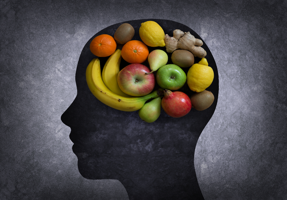 Image of fruits in the shape of a brain in a silhouette of a head