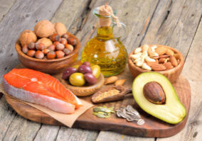Image of healthy fats arrayed on a counter, like salmon and avocado