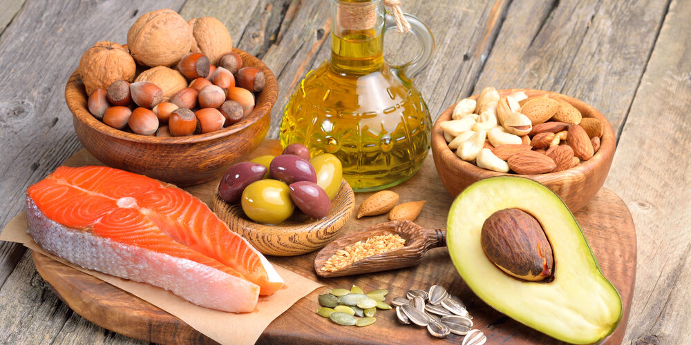 Image of healthy fats arrayed on a counter, like salmon and avocado