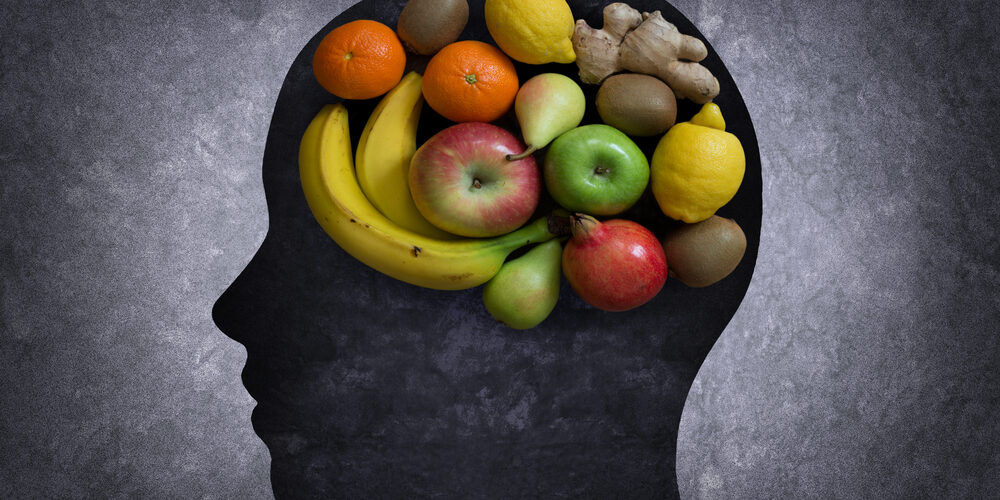 Image of fruits in the shape of a brain in a silhouette of a head
